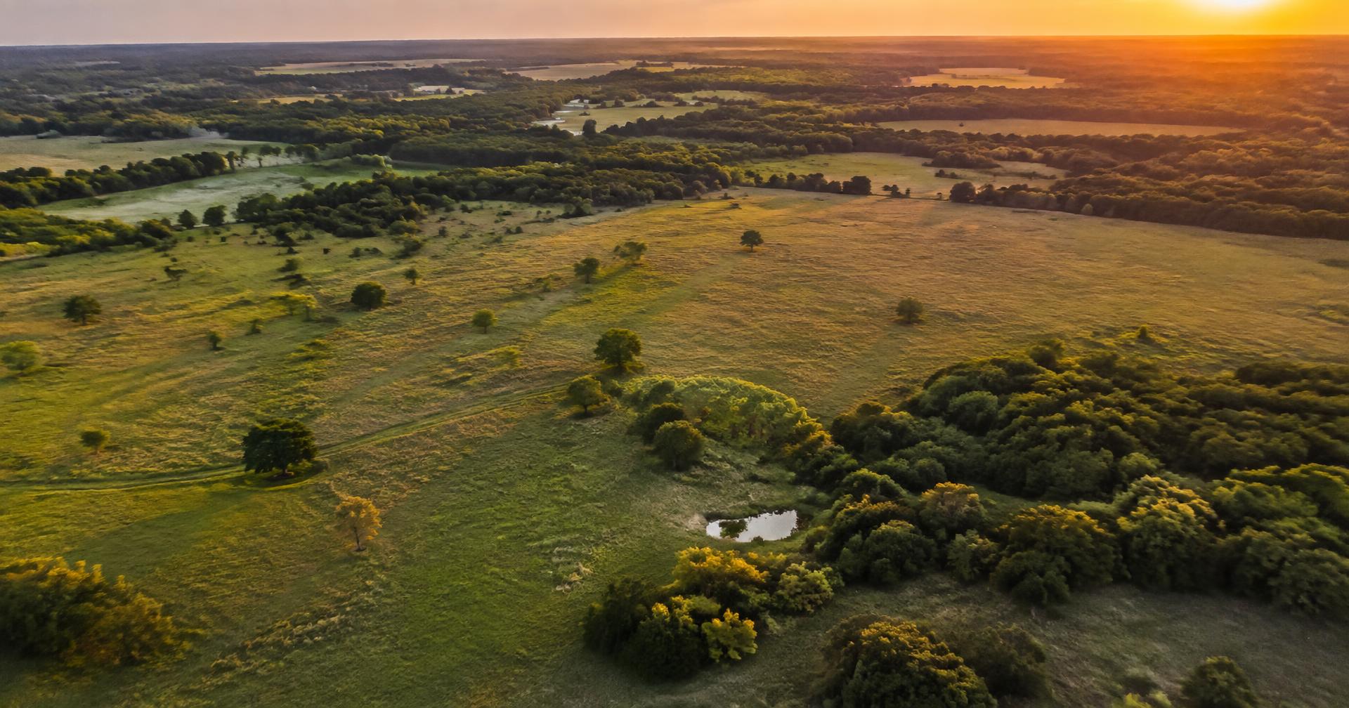 Aerial view of open rural acreage in North Texas at evening light